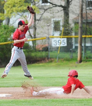 Durfee's Nathan Ladeira catches a high throw to second base but can't get on the ground fast enough to tag New Bedford's Abdul Vargas on a steal.
