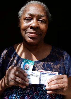 In this Monday, April 24, 2017 photo, Gladys Harris of Milwaukee holds some of the forms of identification she brought with her to the polls in the 2016 presidential election. She was unable to vote because she had lost her driver's license a few days before and thought one of the many other cards she had with her would work. She was given a provisional ballot but was unable to return with a proper ID in time. It was the first presidential election to be held under a new state law requiring a driver's license, state ID, passport, military ID, naturalization papers or tribal ID to vote. (AP Photo/Carrie Antlfinger)