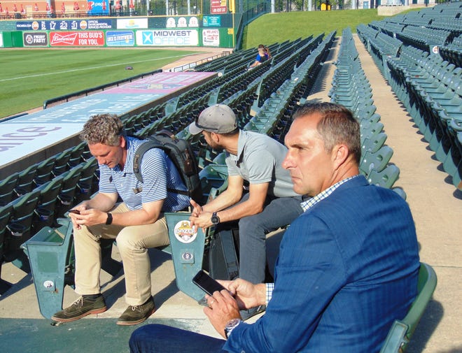 DAVE EMINIAN/JOURNAL STAR St. Louis Cardinals general manager John Mozeliak (right) and assistant GM Mike Girsch (left) watched the Peoria Chiefs play West Michigan at Dozer Park on Tuesday.
