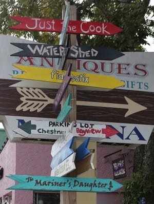 Hand-painted signs point to various businesses throughout downtown St. Andrews in 2015. With the St. Andrews CRA set to expire in 2019, Panama City took the first step Tuesday to renew the CRA early. [NEWS HERALD FILE PHOTO]