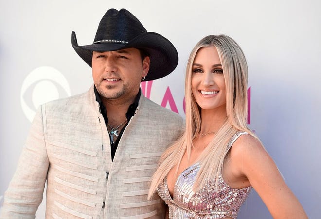 FILE - In this April 2, 2017, file photo, Jason Aldean, left, and Brittany Kerr arrive at the 52nd annual Academy of Country Music Awards at the T-Mobile Arena in Las Vegas. Aldean announced on May 8, 2017, that he and Kerr are expecting their first child together. (Photo by Jordan Strauss/Invision/AP, File)
