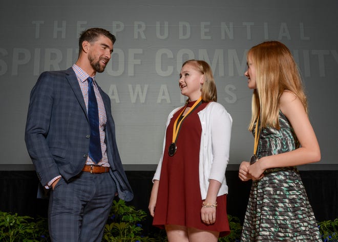 Olympic gold medalist Michael Phelps, left, talks with Elizabeth Lipp of Mountain Brook, center, and Louise Adair of Tuscaloosa, right, on Sunday night at the Smithsonian’s National Museum of Natural History. Elizabeth and Louise were honorees at the Prudential Spirit of Community Awards. [Photo by Prudential Financial]