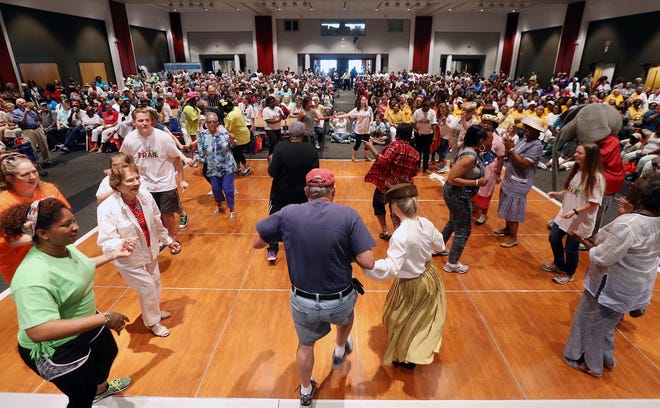 Members of the West Alabama Regional Commission Dance Team dance with seniors at the 29th annual Senior Appreciation Day Celebration hosted by the Area Agency on Aging of West Alabama at the Bryant Conference Center on May 25, 2016. About 1,000 people attended the event which included vendors and exhibitors with information for senior citizens, live music and dancing, games and lunch. May is Older Americans Month. The event recognizes and honors the older population in the seven counties served by the agency in the West Alabama community. [File photo / Michelle Lepianka Carter]