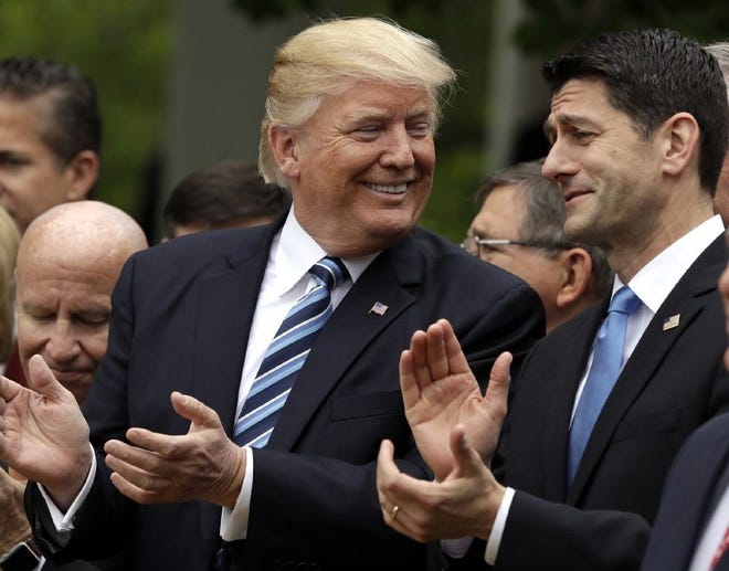 In this May 4, 2017, photo, President Donald Trump talks to House Speaker Paul Ryan of Wis. in the Rose Garden of the White House in Washington, after the House pushed through a health care bill.