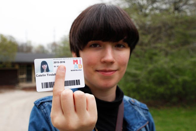 In this Apri photo, Catelin Tindall holds her expired student ID from the Milwaukee Institute of Art and Design at Cannon Park in front of the building where she tried to vote during the November 2016 presidential election. Tindall tried to vote during the November 2016 presidential election, but had to cast a provisional ballot because she didn’t have a Wisconsin ID. She then got an ID, but her work schedule prevented her from going to the county clerk’s office with the ID so her vote would count. Wisconsin residents denied the right to vote last fall blame the state’s GOP-backed voter ID law, which was in effect for the first time in a presidential election. (AP Photo/Carrie Antlfinger)