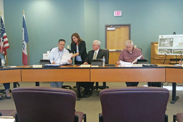 Dallas County Auditor Julia Helm (middle) walks the Board of Supervisors through the process of verifying the vote tallies during the official canvass for the bond referendum on May 9. PHOTO BY CLINT COLE/THE PERRY CHIEF