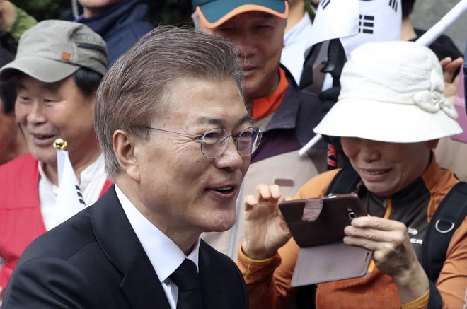 Newly elected South Korean President Moon Jae-in greets his neighbors and supporters as he leaves his house in Seoul, South Korea, Wednesday, May 10, 2017. Hours after celebrating his election win with thousands of supporters in wet Seoul streets, new South Korean President Moon on Wednesday was quickly thrown into the job of navigating a nation deeply split over its future and faced with growing threats from North Korea and an uneasy alliance with the United States. THE ASSOCIATED PRESS
