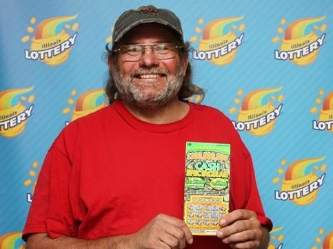Supplied photo

Joe Weis holds his winning lottery scratch-off ticket in this undated photo provided by the Illinois Lottery.
