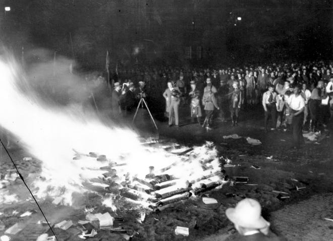 A crowd gathers to witness thousands of books, considered to be "un-German," burn in Opera Square in Berlin, Germany, during the Buecherverbrennung book burnings on May 10, 1933. (AP Photo)