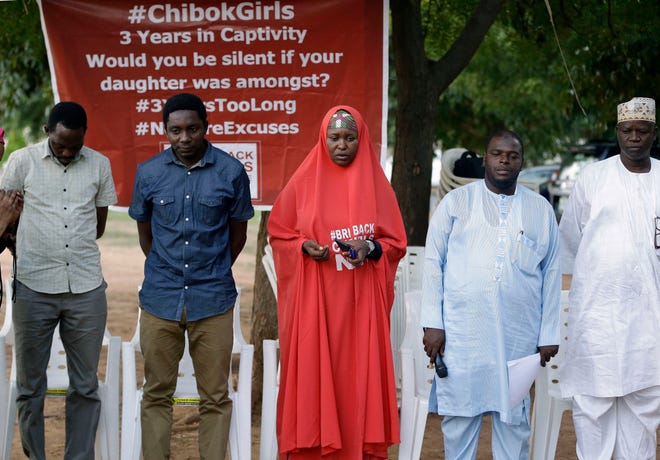 Campaigners observe a minute silent for the remaining Kidnapped schools during their daily sit outs in Abuja, Nigeria. Tuesday. May 9, 2017. One of the Chibok schoolgirls kidnapped by Boko Haram in 2014 and who had the opportunity to be released on Saturday chose to stay with her husband, Nigeria's president spokesman said Tuesday. Garba Shehu said that originally they had been negotiating the release of 83 girls, but one said she wanted to remain. (AP Photo/Sunday Alamba)