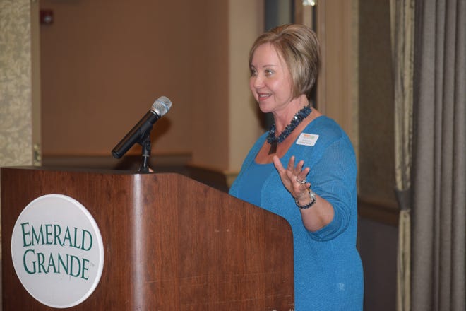 Teresa Bolton, IMPACT 100's board president, announces the group's membership of 408 women Tuesday at the Emerald Grande in Destin. [ANNIE BLANKS/DAILY NEWS]