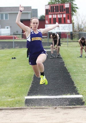 Alyssa Hagen of Bronson flies through the air in the long jump event on Wednesday.