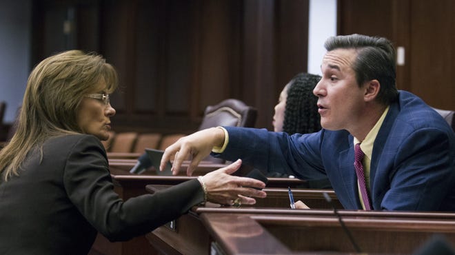 Sen. Rene Garcia, R-Hialeah, and Sen. Denise Grimsley, R-Lake Placid, talk during an education budget discussion Monday on the floor of the Senate at the Florida Capitol in Tallahassee. [MARK WALLHEISER/THE ASSOCIATED PRESS]