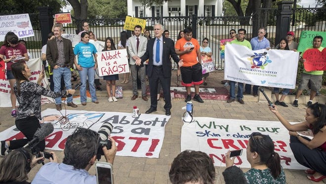 U.S. Rep. Lloyd Doggett gathers with protesters outside of the Governor’s Mansion in downtown Austin on Monday to respond to Gov. Greg Abbott’s signing of Senate Bill 4 on Facebook Live.