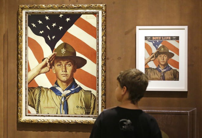 In this July 22, 2013, file photo, an 11-year-old boy looks over a Boy Scout-themed Norman Rockwell exhibition at the Church History Museum in Salt Lake City, Utah. The Mormon church, the largest sponsor of Boy Scouts troops in the United States, announced Thursday, May 11, 2017, it is pulling older teenagers from the organization as the religion takes a step toward developing its own global scouting-like program. THE ASSOCIATED PRESS