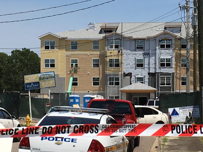 Jacksonville police said two construction workers were loading supplies into a third-story window from a wooden crate hoisted by this lift Thursday afternoon when the crate fell, pulling the workers down with it. It’s not clear if they were wearing harnesses. (Garrett Pelican/Florida Times-Union)