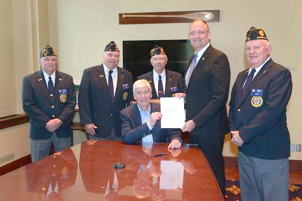 Gov. Rick Snyder signed state Rep. Eric Leutheuser’s bill into law honoring military hero, James Bondsteel. (Pictured from left to right) Carl Sheffer, Gerald Arno, Charles Pfau, Gov. Rick Snyder, Rep. Eric Leutheuser and Robert Snow. 

[COURTESY PHOTO]