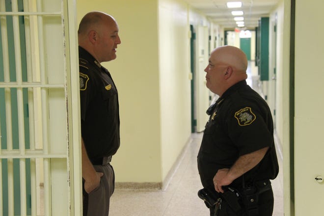 Lt. Jason Stiverson, the jail administrator, speaks with Correctional Officer Jeff Miller Wednesday morning in the Hillsdale County Jail. COREY MURRAY PHOTO