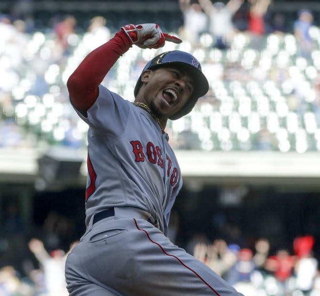 Boston's Mookie Betts reacts as he rounds first after hitting a three-run home run during the ninth inning to beat Milwaukee Thursday afternoon, 4-1. [AP photo]