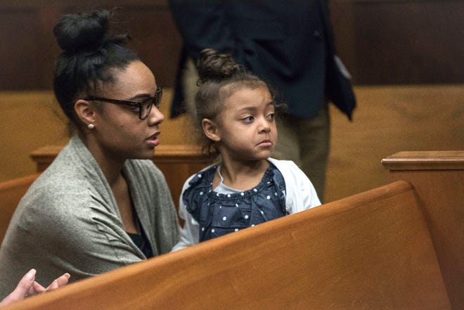 In this Wednesday, April 12, 2017, file photo, Shayanna Jenkins Hernandez, fiancee of former New England Patriots tight end Aaron Hernandez, sits in the courtroom with the couple's daughter during jury deliberations in Hernandez's double-murder trial at Suffolk Superior Court in Boston.
