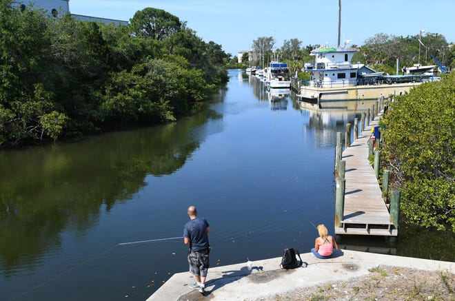 People fish from a seawall along Bowlees Creek. The Manatee County Planning Commission recommended denial of the proposed Blu Harbor condominium development with a yacht club at U.S. 41 and Bowlees Creek. [HERALD-TRIBUNE STAFF PHOTO / MIKE LANG]