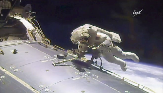 In this image made from video provided by NASA, astronaut Jack Fischer works outside the International Space Station on Friday, May 12, 2017. Fischer and Peggy Whitson, not pictured, performed the station's 200th spacewalk. (NASA via AP)