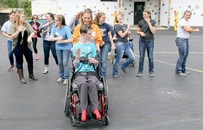 Members of the Camden-Frontier High School Project Unify group dance the “Cha Cha Slide” with Michael Caskey a student at Greenfield School. [ANDY BARRAND PHOTO]