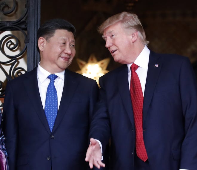 In this April 6, 2017, file photo, Chinese President Xi Jinping, left, smiles at U.S. President Donald Trump as they pose together with their wives for photographers before dinner at Mar-a-Lago in Palm Beach, Fla. China will finally open its borders to U.S. beef while cooked Chinese poultry is closer to hitting the American market as part of a U.S.-China trade agreement. Trump administration officials hailed the deal as a significant step in their efforts to boost U.S. exports and even America's trade gap with the world's second-largest economy. THE ASSOCIATED PRESS
