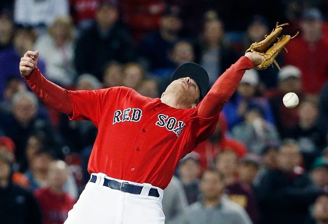 Boston's Josh Rutledge cannot field a pop-up by Tampa Bay's Derek Norris during the ninth inning. [The Associated Press]
