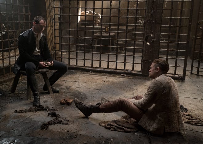 Vortigern (Jude Law) holds Arthur (Charlie Hunnam) captive. (Photo by Daniel Smith)