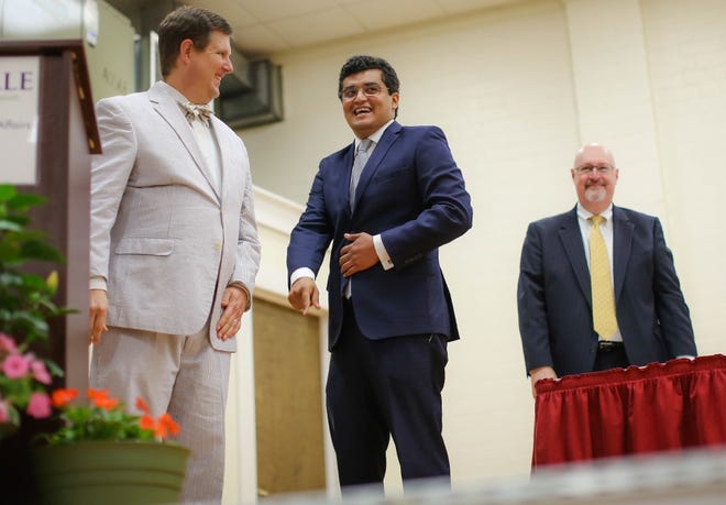 Gainesville Mayor Lauren Poe, City Commissioner David Arreola and City Commissioner Harvey Ward smile after a swearing-in ceremony for the new commissioners on May 4. [Rob C. Witzel/The Gainesville Sun]