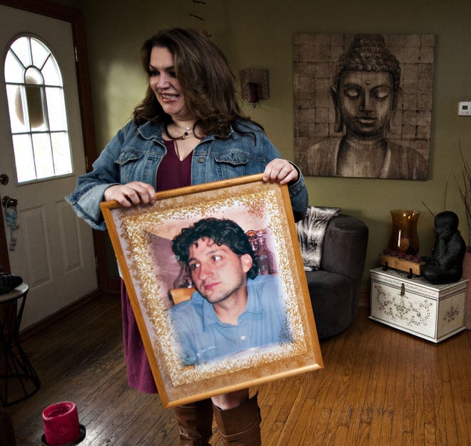 Ellen Lindeman holds a photograph of her husband, Ted Lindeman, at her Warminster home Thursday, March 30, 2017. After the death of her husband, Ellen started the Ted Lindeman Outreach Foundation.