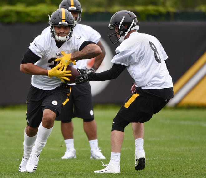 Quarterback Nick Schuessler (8) hands off to running back James Conner (8) during the first day of Steelers rookie minicamp on Friday at the UPMC Rooney Sports Complex in Pittsburgh.