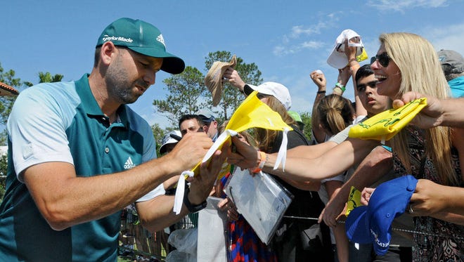Sergio Garcia signs an autograph on a Masters flag for Michele Williams after she said only he and Justin Rose could sign it because “it was the greatest finish in Masters’ history and any other and anybody else would have ruined it” her husband, Kris, said. (Terry Dickson/Florida Times-Union)