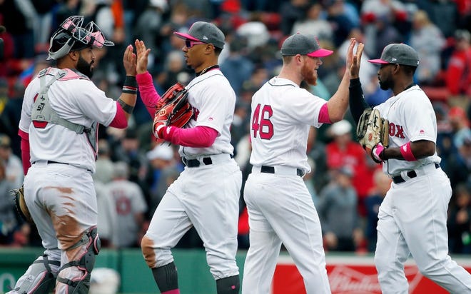 Red Sox players, from left, Sandy Leon, Mookie Betts, Craig Kimbrel and Jackie Bradley Jr. celebrate Saturday's win.