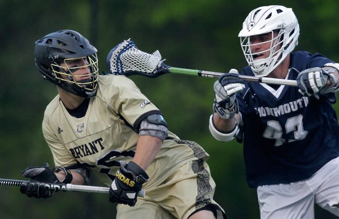 Bryant's Ryan Sharpe protects the ball from Monmouth's Chandler Vanderbeek in Wednesday's game.