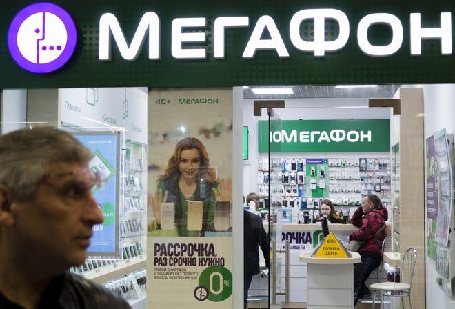 People inside a Megafon mobile phones shop Saturday in Moscow. [The Associated Press]