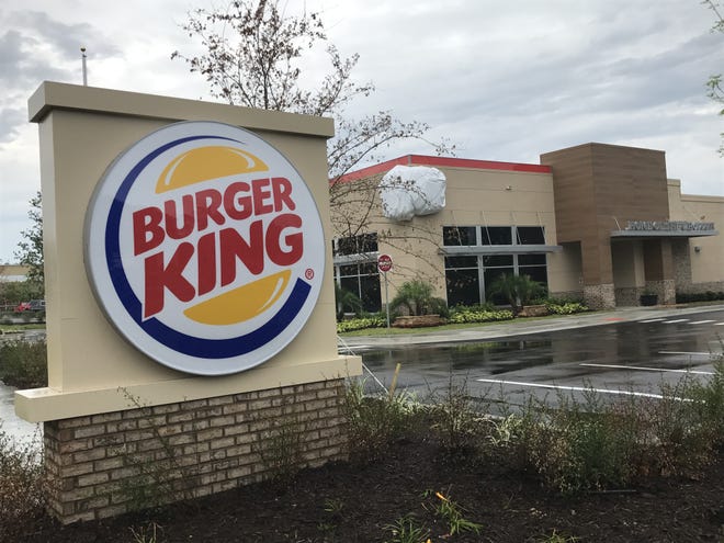 A tribute to Burger King's signature sandwich, the Whopper, remains under wraps where it has been installed onto the corner of the renovated restaurant on West Newberry Road in front of Oaks Mall in Gainesville. Company officials say the concept for the Whopper was hatched by Burger King founders 60 years ago while they were passing through Gainesville. [Staff photo]