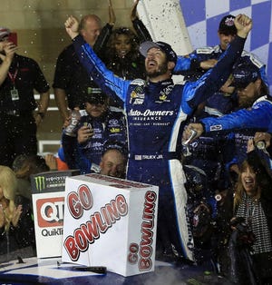 Martin Truex Jr. celebrates in Victory Lane after winning the NASCAR Monster Cup auto race at Kansas Speedway in Kansas City, Kan., Saturday, May 13, 2017. (AP Photo/Orlin Wagner)