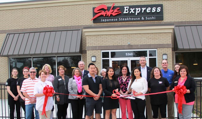Cutting the ribbon are owners Linda Park, left, and Lisa Nguyen. Others, from left, are Sake Express staff members Bethany McGinnas and Victoria DiPietro, Thomas Garrone and Jane DuBois (holding ribbon), Carey Roberts of Carey Roberts Design, Gaston Chamber CEO Anissa Starnes and Membership Director Angela Saunders, Montcross Area Chamber President Ted Hall, Michael Park, Sally Dunn of Alliance Bank, Susan Gauff of Lake Wylie Bedding, Elaine Dimeo of George Stowe Insurance, Tommy Pope, Tisha Walker, Doug McSpadden of McSpadden Custom Homes, Michela King, and Lisa Jubenville of the Lake Wylie Chamber. [MONTCROSS AREA CHAMBER/SPECIAL TO THE GASTON GAZETTE]