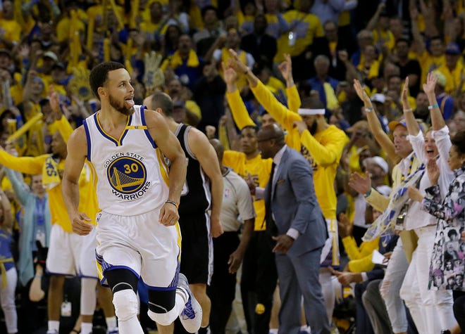 Golden State Warriors guard Stephen Curry (30) reacts after scoring against the San Antonio Spurs during the second half of Game 1 of the NBA basketball Western Conference finals in Oakland, Calif., Sunday, May 14, 2017. The Warriors won 113-111. (AP Photo/Jeff Chiu)