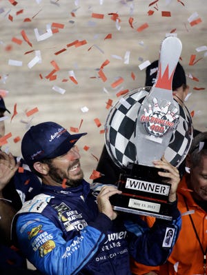 Martin Truex Jr. celebrates in Victory Lane after winning the NASCAR Monster Cup auto race at Kansas Speedway in Kansas City, Kan., Saturday, May 13, 2017. (AP Photo/Colin E. Braley)