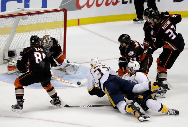 Anaheim Ducks goalie John Gibson, second from left, blocks a shot during the third period of Game 2 of the Western Conference final in the NHL hockey Stanley Cup playoffs against the Nashville Predators, Sunday, May 14, 2017, in Anaheim, Calif. (AP Photo/Chris Carlson)