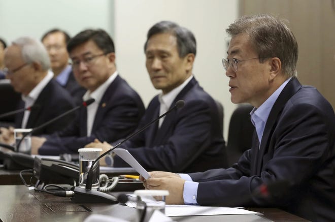 South Korean President Moon Jae-in, right, presides over a meeting of the National Security Council at the presidential Blue House in Seoul, South Korea, May 14, 2017. North Korea on Sunday test-launched a ballistic missile that landed in the Sea of Japan, the South Korean, Japanese and U.S. militaries said. The launch is a direct challenge to the new South Korean president elected four days ago and comes as U.S., Japanese and European navies gather for joint war games in the Pacific. (Yonhap via AP)