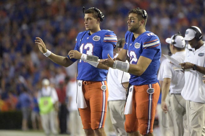 Florida quarterbacks Austin Appleby (12) and Feleipe Franks (13) signal in a play from the sideline during a game last season. UF coach Jim McElwain said Monday he's glad the Gators decided not to pull the redshirt off Franks last season and commit to Appleby. [Associated Press]