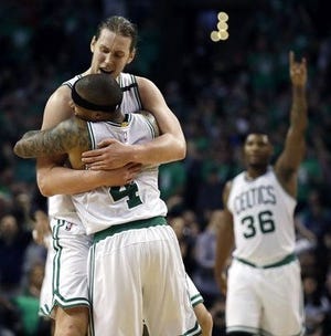 Isaiah Thomas (4) exchanges a hug with Kelly Olynyk after they helped defeat the Cavaliers in Game Seven on Monday night to advance to the Eastern Conference finals. Thomas had 29 points and 12 assists and Olynyk had 26 points, 14 in the final quarter, for the Celtics.