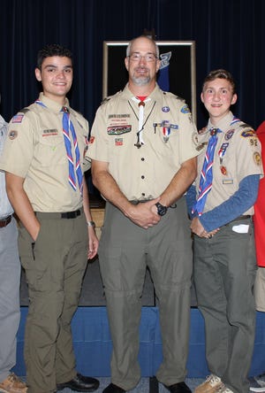 Anthony Vagnozzi, Scoutmaster of Troop 92, David Estridge and Luke Satterfield after the two teenagers received their Eagle awards. [Special to The Star]
