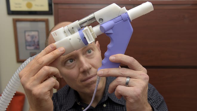 Robert M. Reed, an associate professor of medicine and a pulmonary and critical care specialist at the University of Maryland, uses a spirometer to measure the rates that people can empty their lungs as well as the total amounts of air that they can blow out. He found while studying an Amish community in Lancaster, Pa., that even a small amount of secondhand smoke exposure can have negative health effects. [Algerina Perna/Baltimore Sun/TNS]