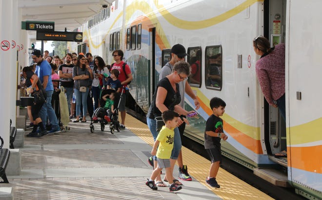 People board a SunRail train in DeBary in 2015. [News-Journal/Jim Tiller]