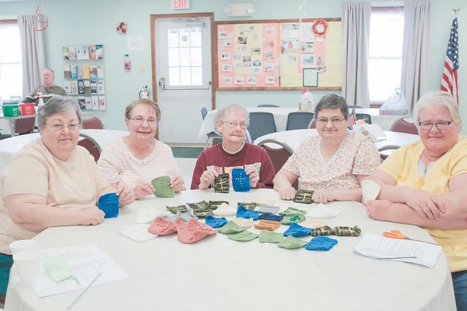 From left, Eileen Kane, Thelma Peerce, Gladys Griffith, Diane Myers and Sandy McGowan of the Knitting Krew at the Greencastle Senior Center display prayer squares that will soon be shipped to active service members.